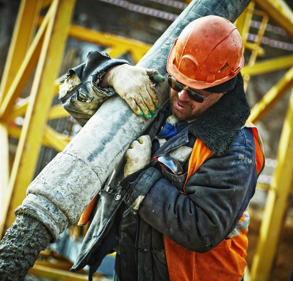 Man Carrying Gray Pipe